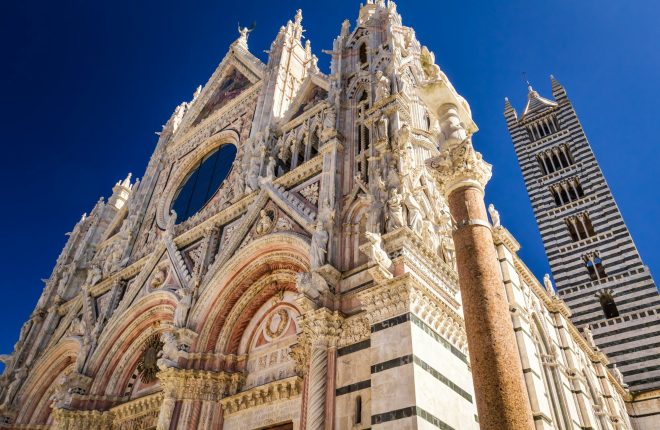 Cathedral of Siena in the summer on a blue sky background